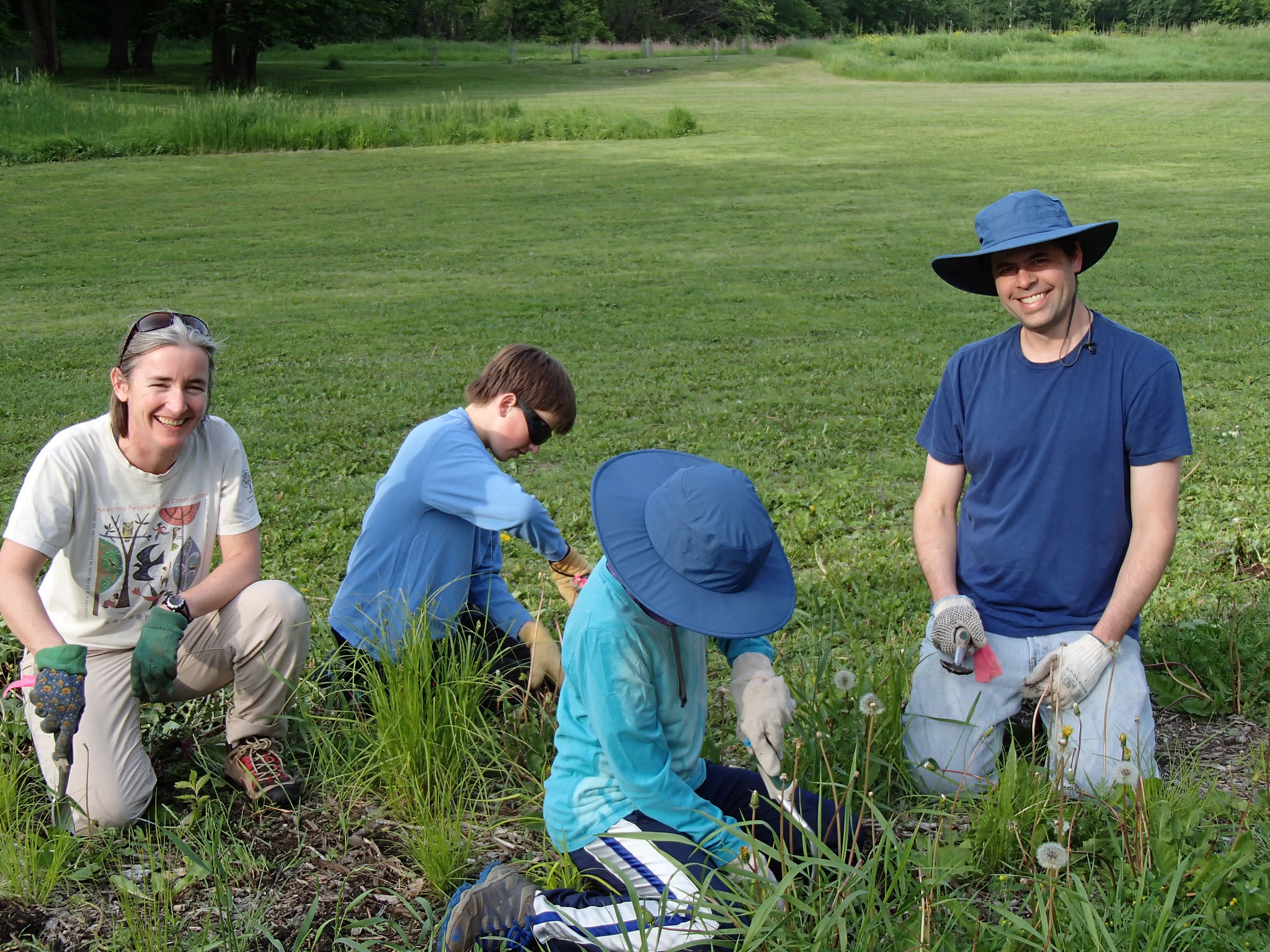Family volunteering at Crosby Farm Regional Park's raingarden.