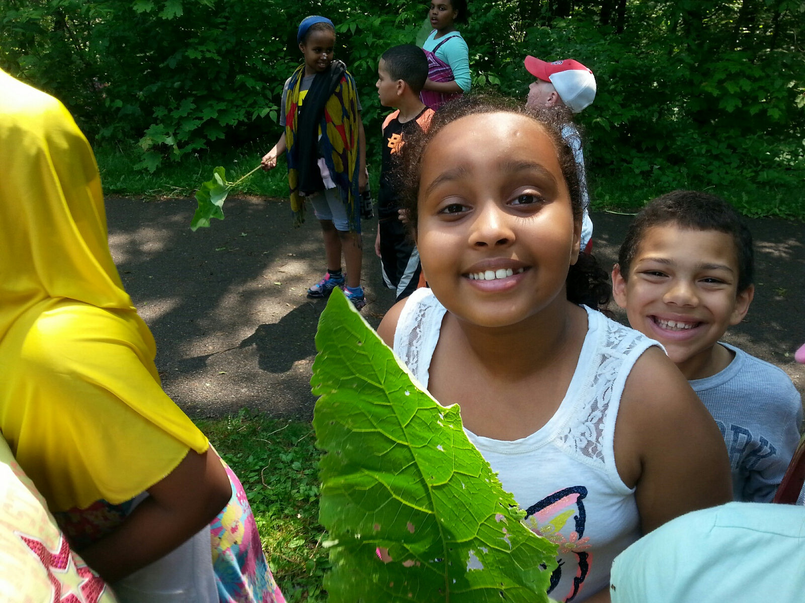 A few younger River Gorge Stewards remove garlic mustard and burdock (with big-enough leaves that double as fans.