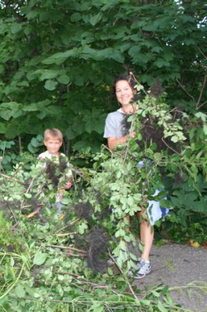 [Photo: Monique and Gavin with a pile of buckthorn.]