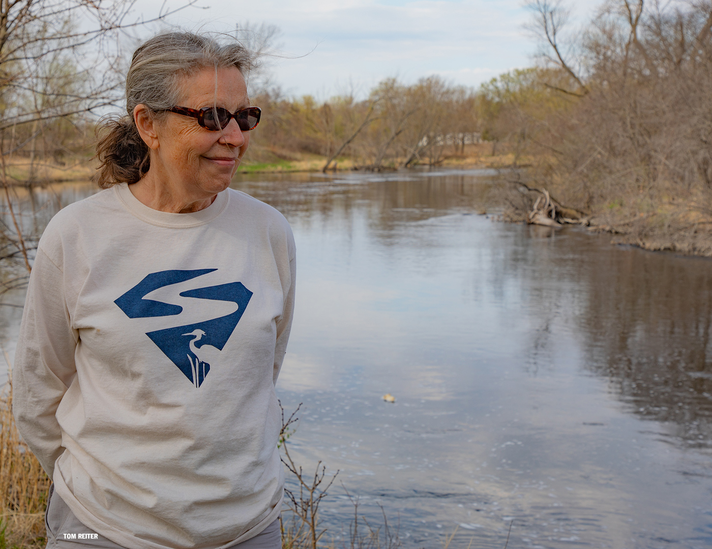 White T with blue river and heron icon on it