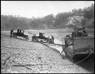 Historical photo of cars loading onto a barge