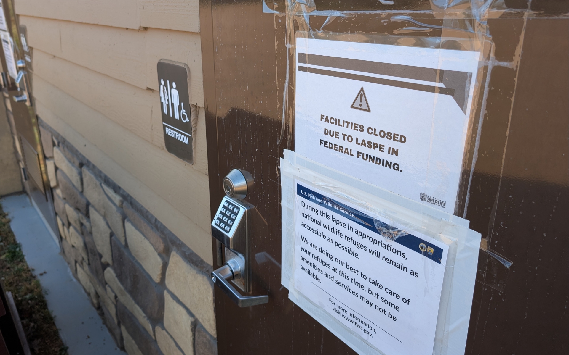 A sign on a USFWS bathroom door saying it is closed due to the federal shutdown.