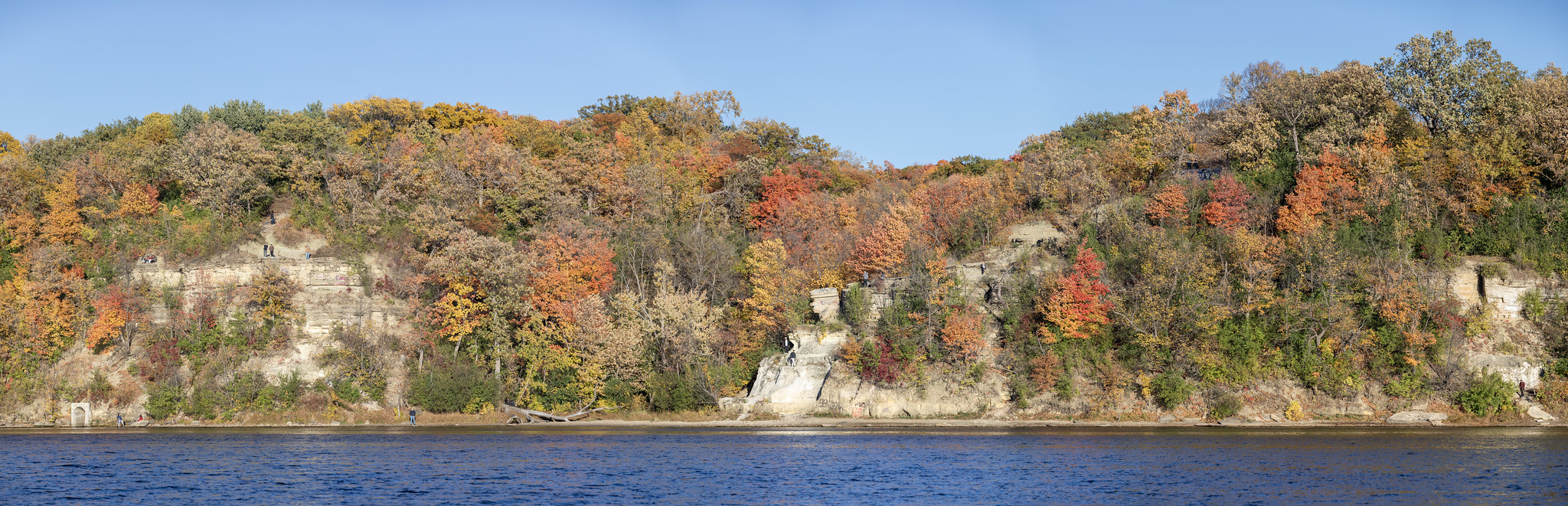 Sandstone bluffs over river with fall colors