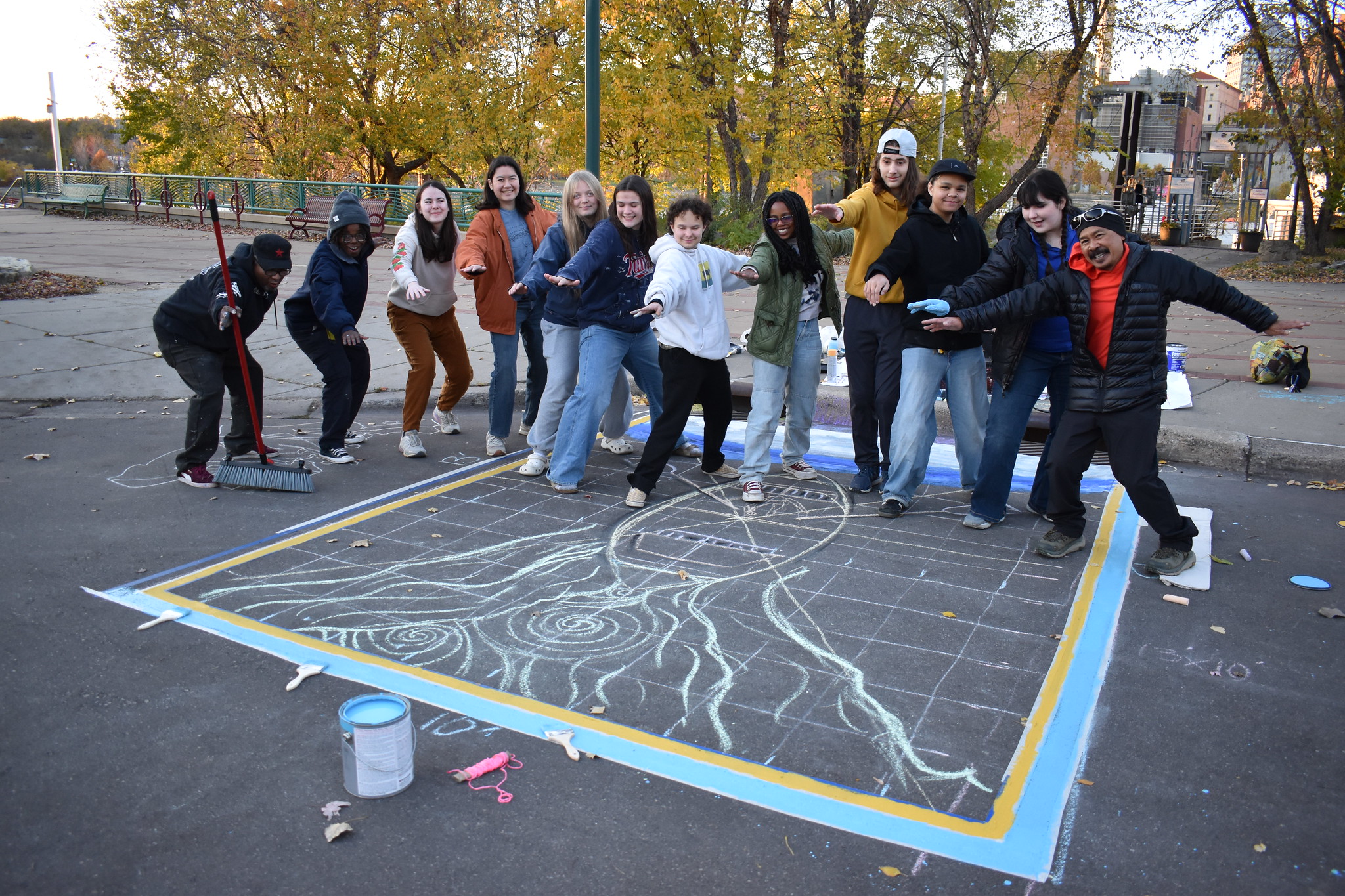 ESI council members and artist pose by storm drain mural sketch