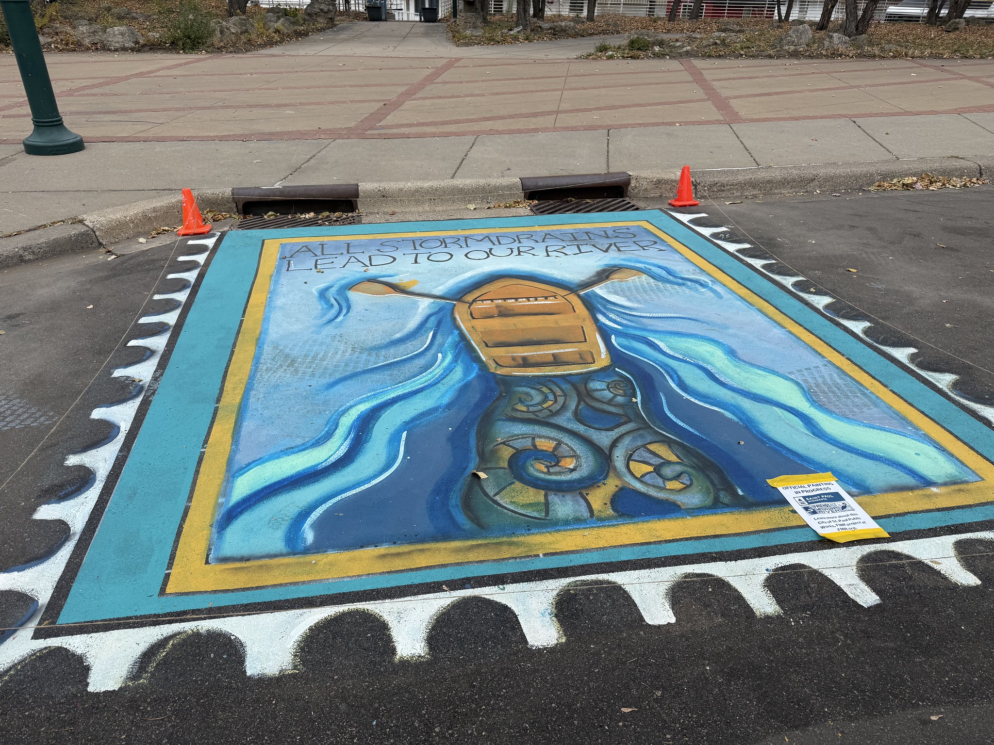 Mural depicting a boat rowing toward the storm drain
