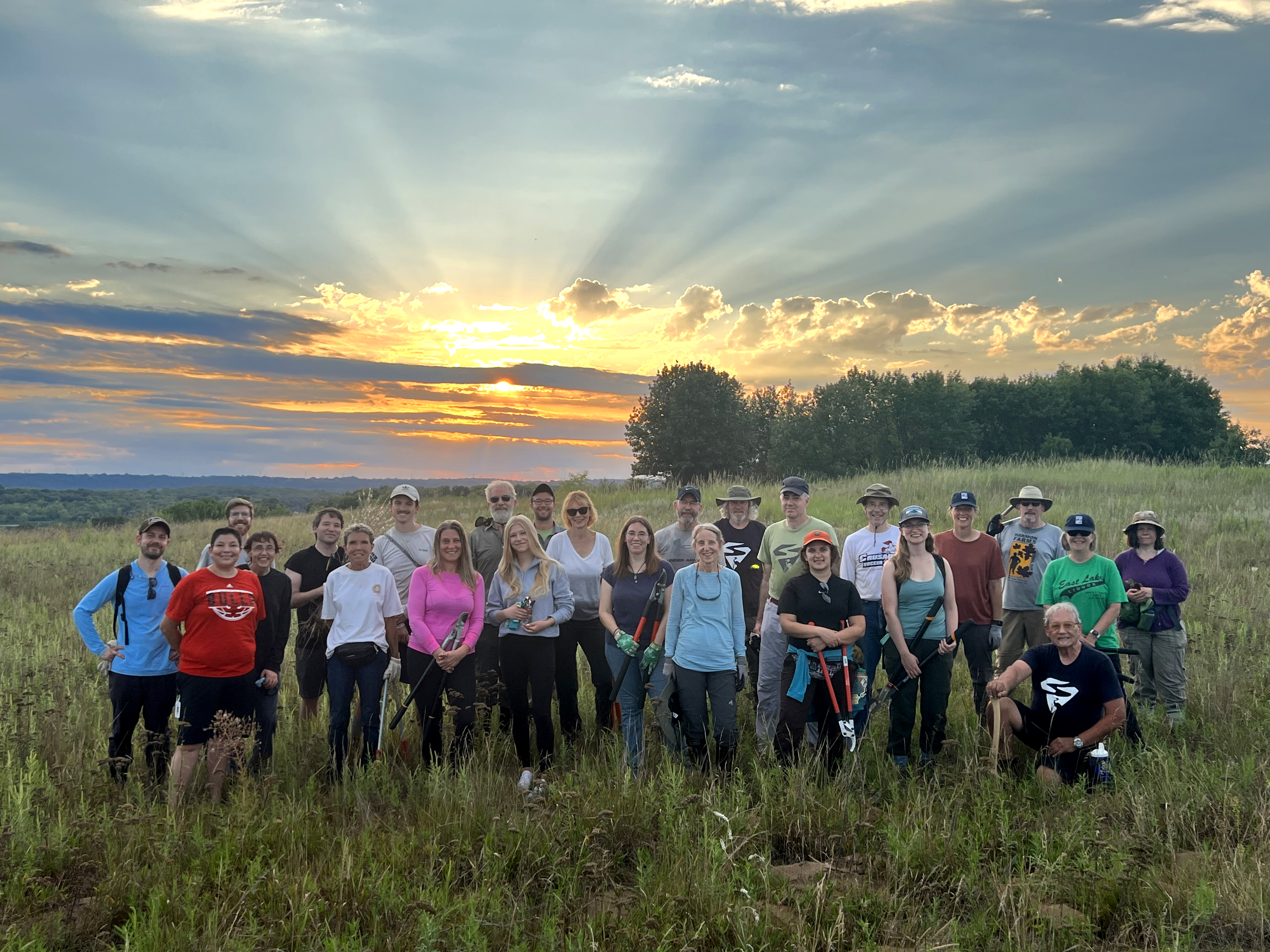 Volunteers in front of sunset