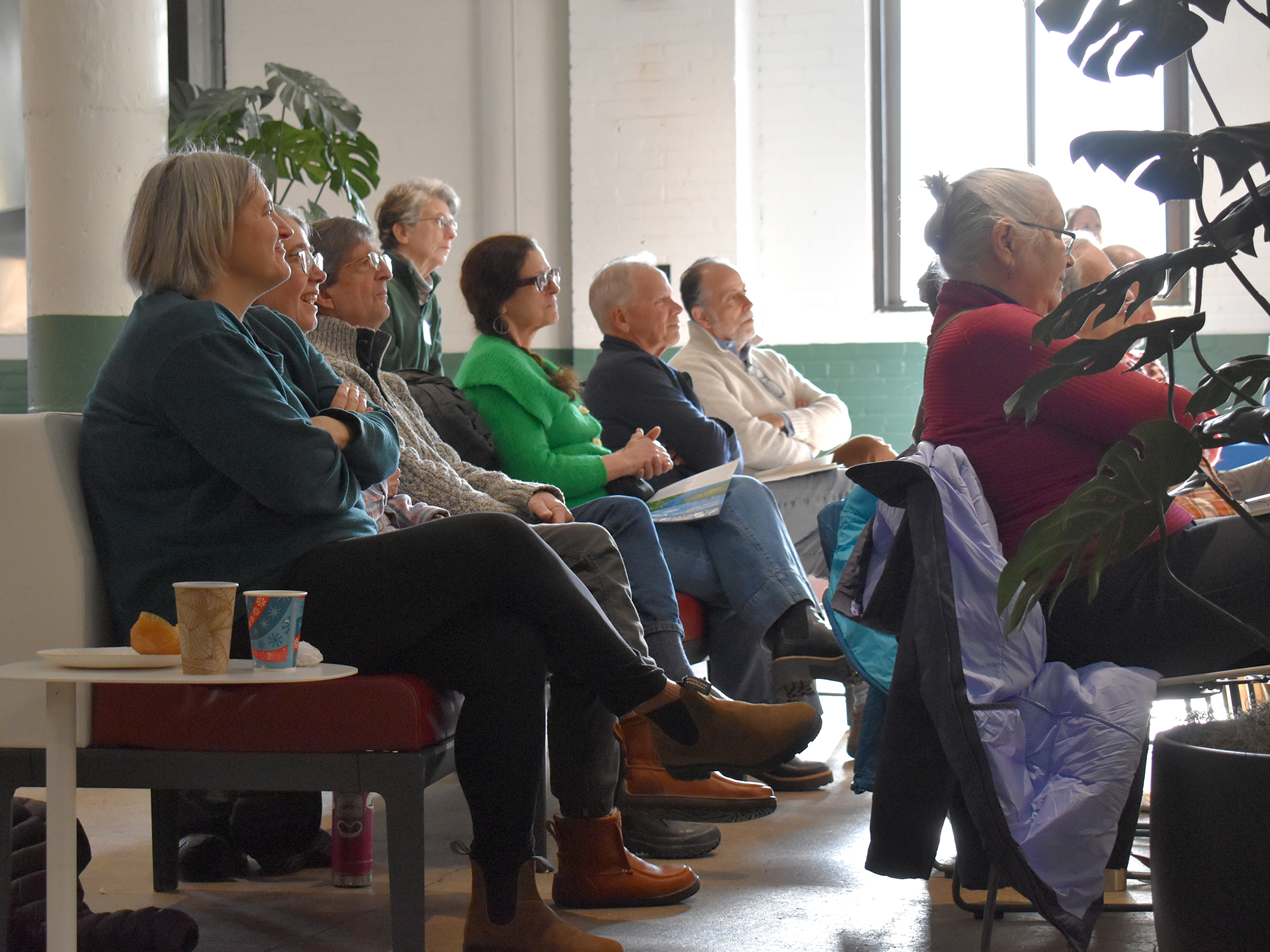 People listen to poetry in gallery space