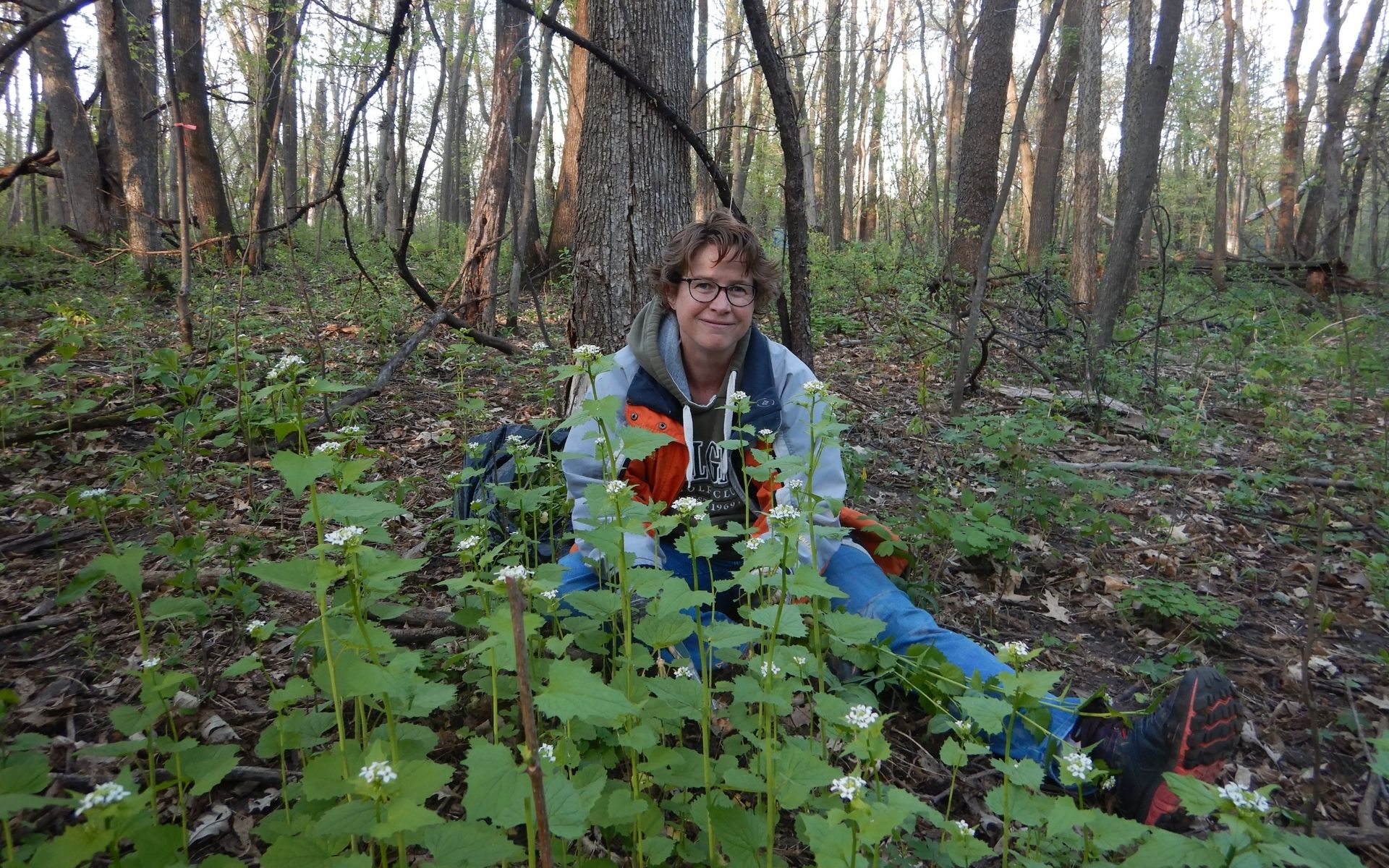 Volunteer Michelle with a patch of garlic mustard at Hampton Woods