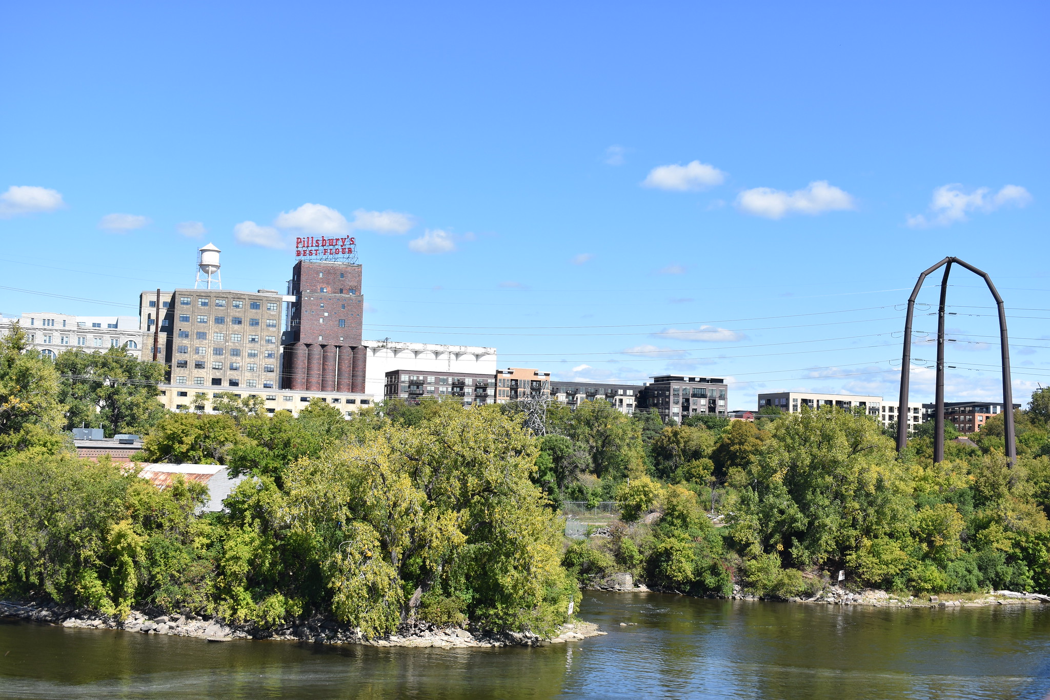 Mississippi riverfront in Minneapolis with buildings, bridge and Pillsbury Flour sign