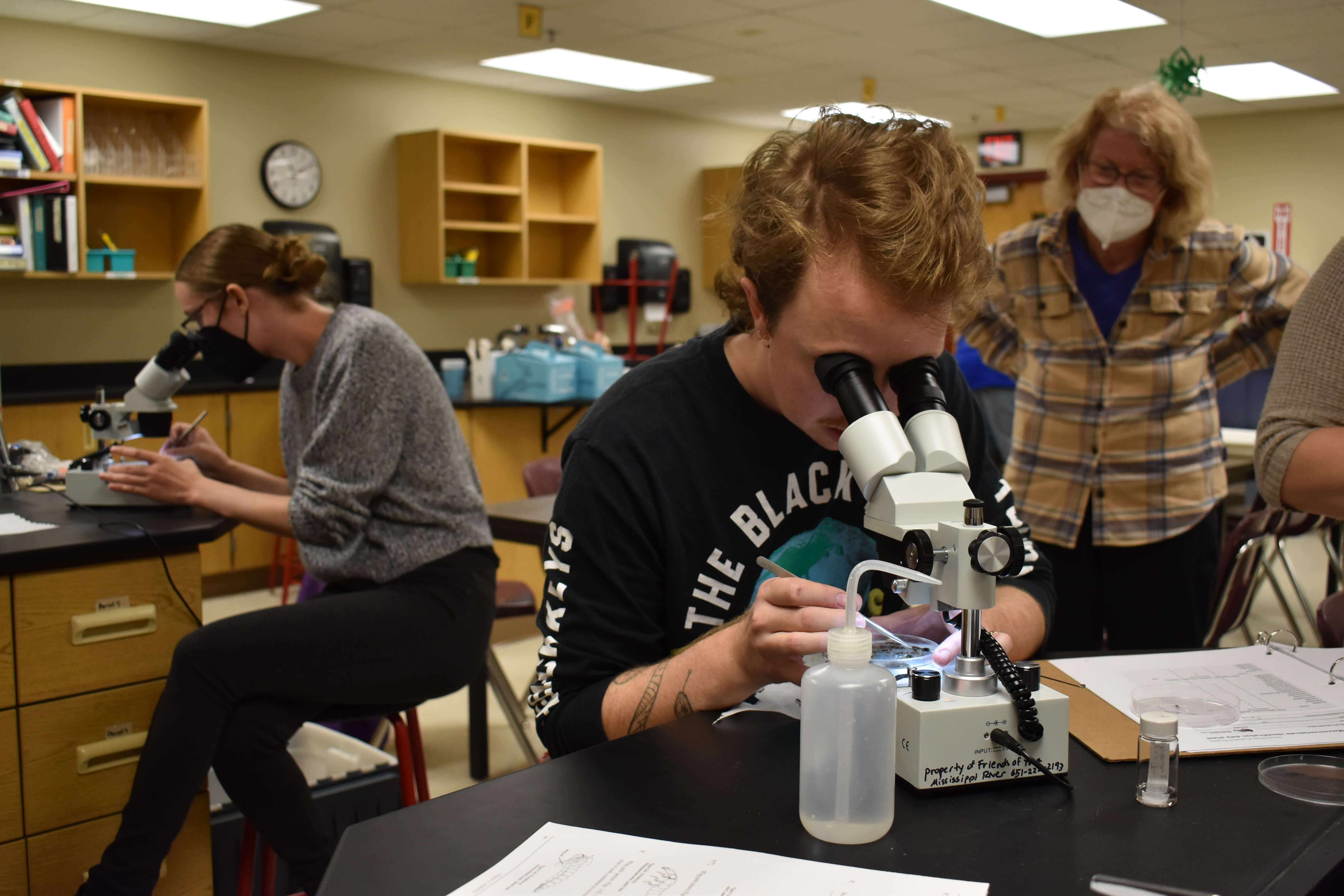 SHEP volunteers look through microscopes to identify macroinvertebrates