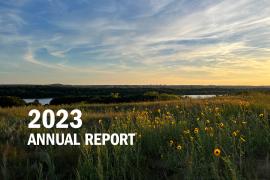 Sunset over Grey Cloud Dunes and river, plus text: 2023 Annual Report
