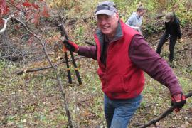 Volunteer with lopper and buckthorn in hand