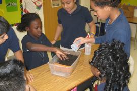 Students participating in a hands-on erosion lesson