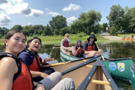 ESI fellows smile in canoes