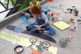 Artists work on the 2019 stormwater mural at Lake Phalen