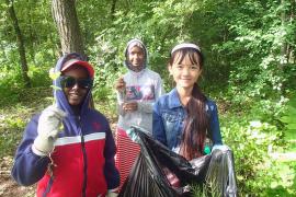 Students remove garlic mustard from the Mississippi River gorge in Minneapolis