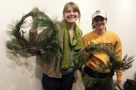 Two workshop participants display their buckthorn wreath creations.