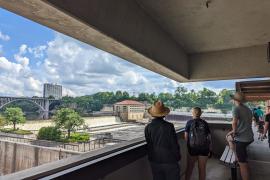 People look out at Ford Dam