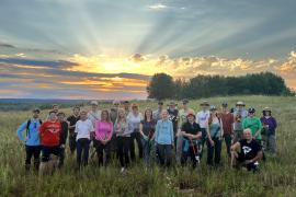 Volunteers in front of sunset