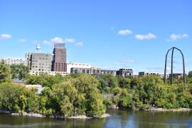 Mississippi riverfront in Minneapolis with buildings, bridge and Pillsbury Flour sign