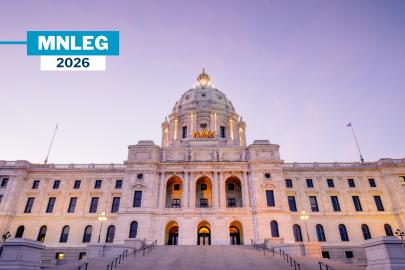 The Minnesota Capitol building in front of a purple evening sky.