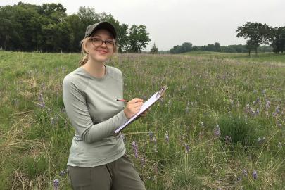 Woman in field tracking observations