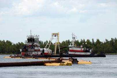 Army Corps boats construct a sill to prevent saltwater intrusion