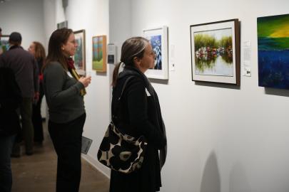 Art for the River 1 Two attendees look at artwork