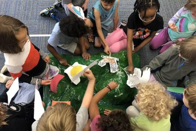 Students work with a watershed model