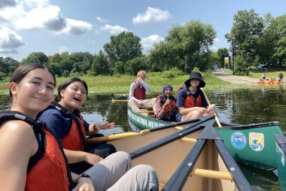 ESI fellows smile in canoes