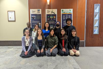 ESI group in front of infographic posters