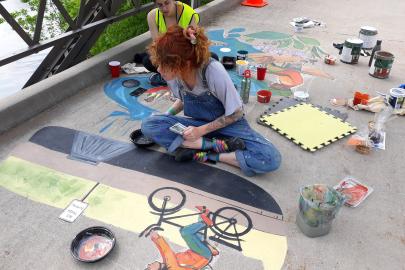 Artists work on the 2019 stormwater mural at Lake Phalen
