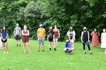 Program participants stand in grass