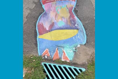 Colorful storm drain mural with text: Just water — no waste 