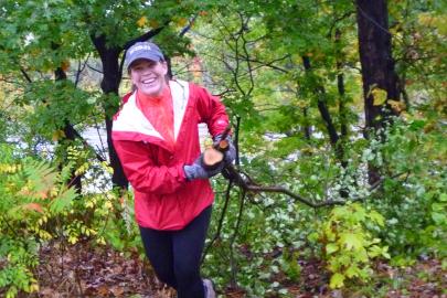 A volunteer hauls buckthorn in the river gorge