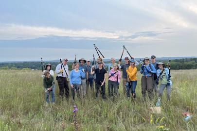 Volunteers pose with loppers on the Grey Cloud Dunes SNA prairie