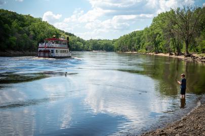 Paddleboat on river with young angler