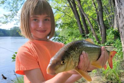 Child holds a shorthead redhorse fish