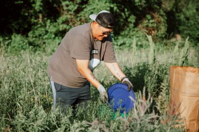 Volunteer tends planter box on Nicollet Island