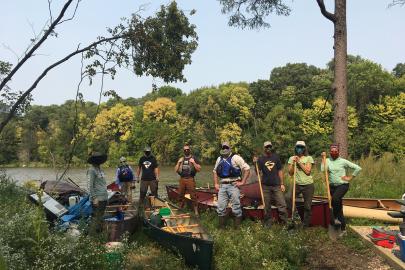 Volunteers with canoes on island
