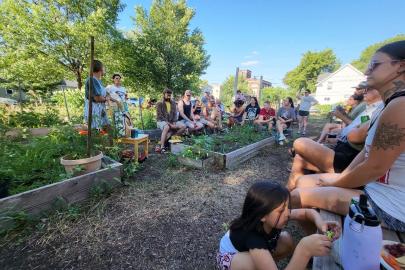 People circled in community garden