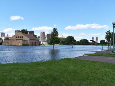 Floodwaters encroach on buildings and paths at St. Paul's Harriet Island.