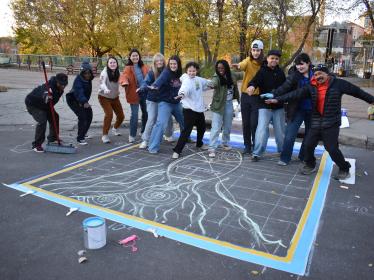 ESI storm drain mural 2025 ESI council members and artist pose by storm drain mural sketch