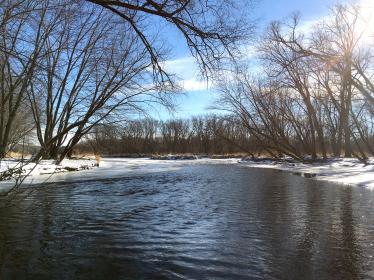 Open river with snow along the banks