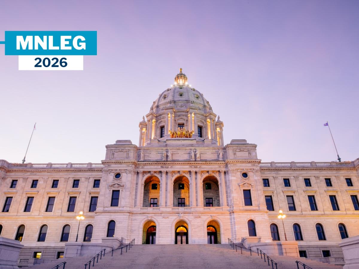The Minnesota Capitol building in front of a purple evening sky.