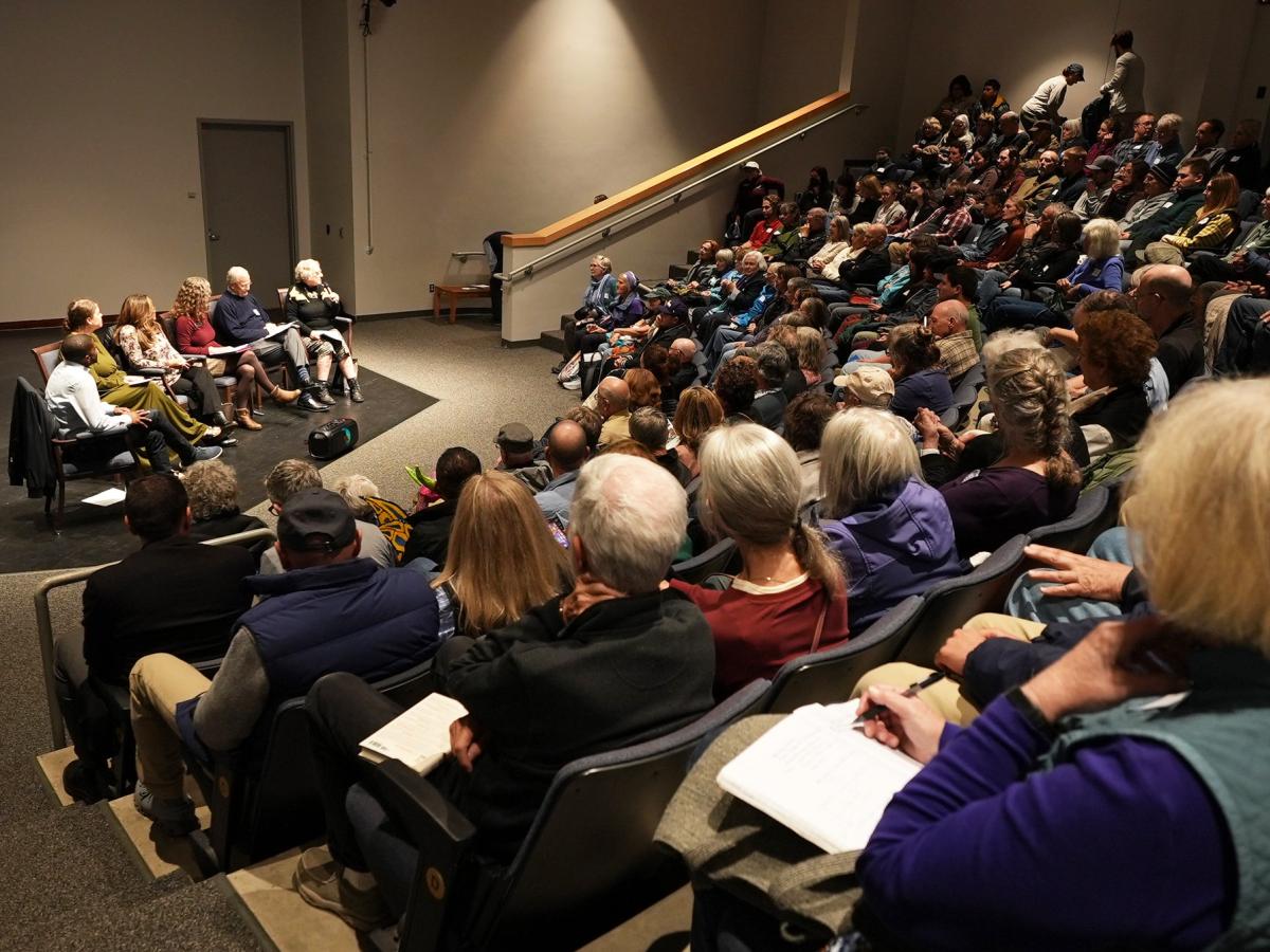 Large town hall audience and speakers