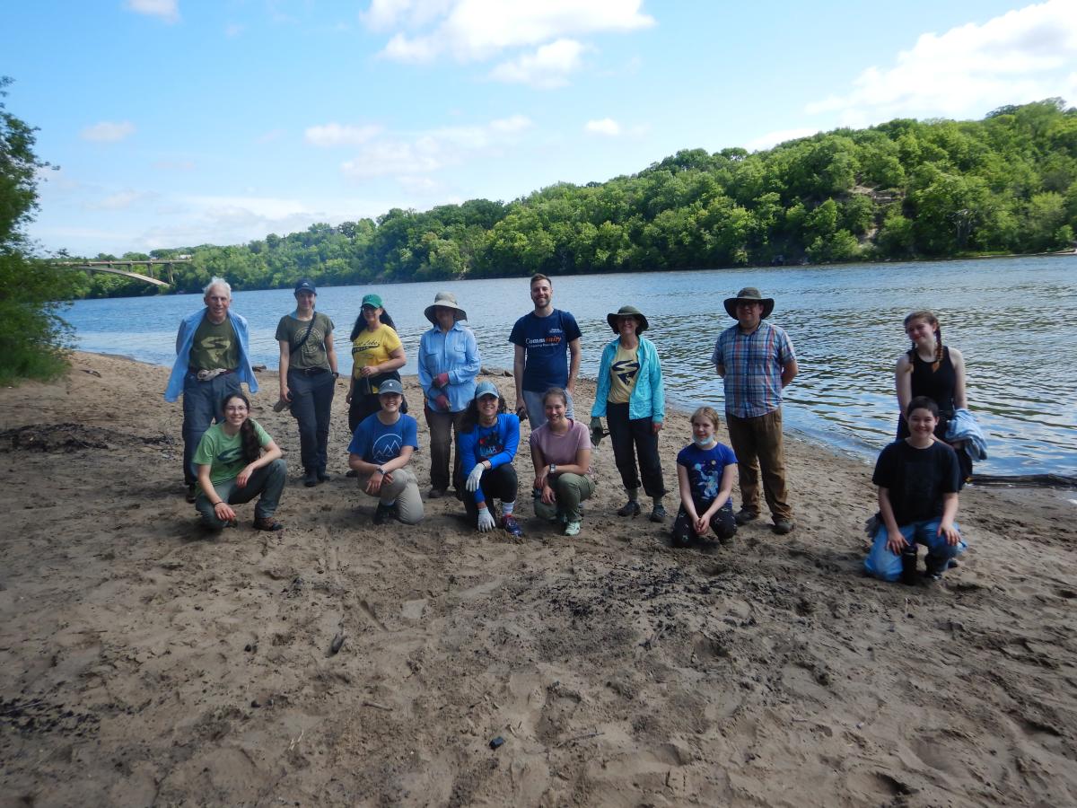 Volunteers pose along the riverbank at the 2021 sand flats garlic mustard pull