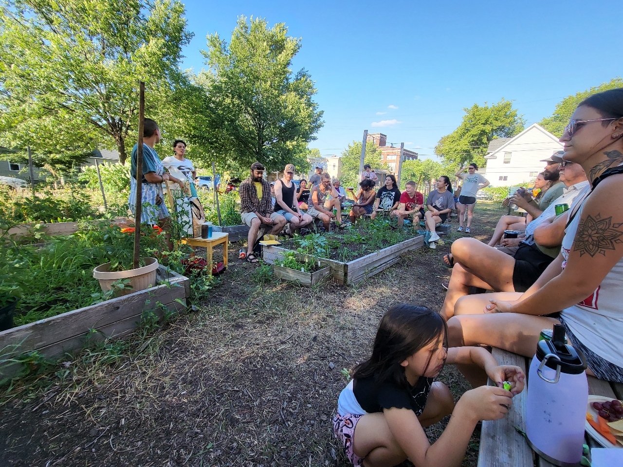 People circled in community garden