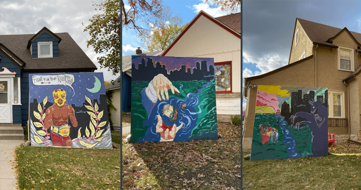 Three large murals with images of community displacement stand in yards