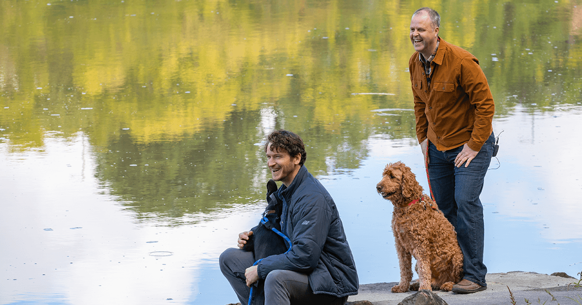 Trevor and Peter with their dogs at the river